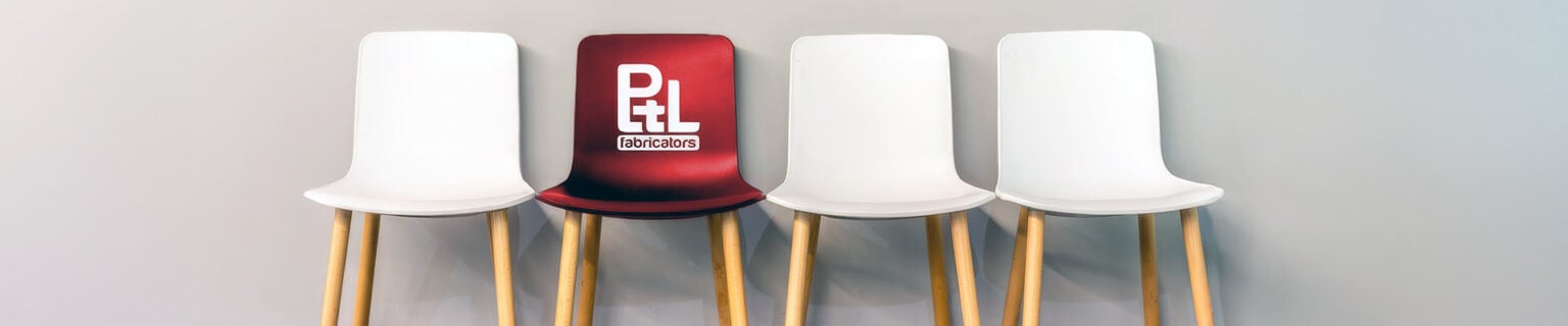Row of chairs with one red PTL Fabricators chair - PTL hiring event